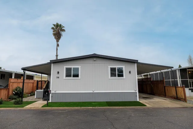 a house that has a tree in front of it