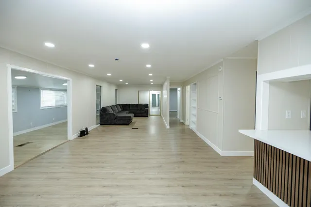 a view of empty room with wooden floor