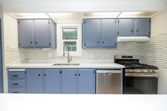 a kitchen with a sink and cabinets