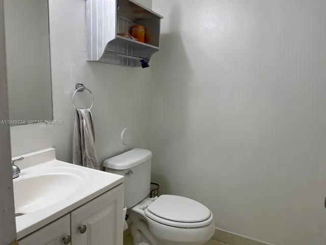 a white toilet sitting next to a bathroom sink
