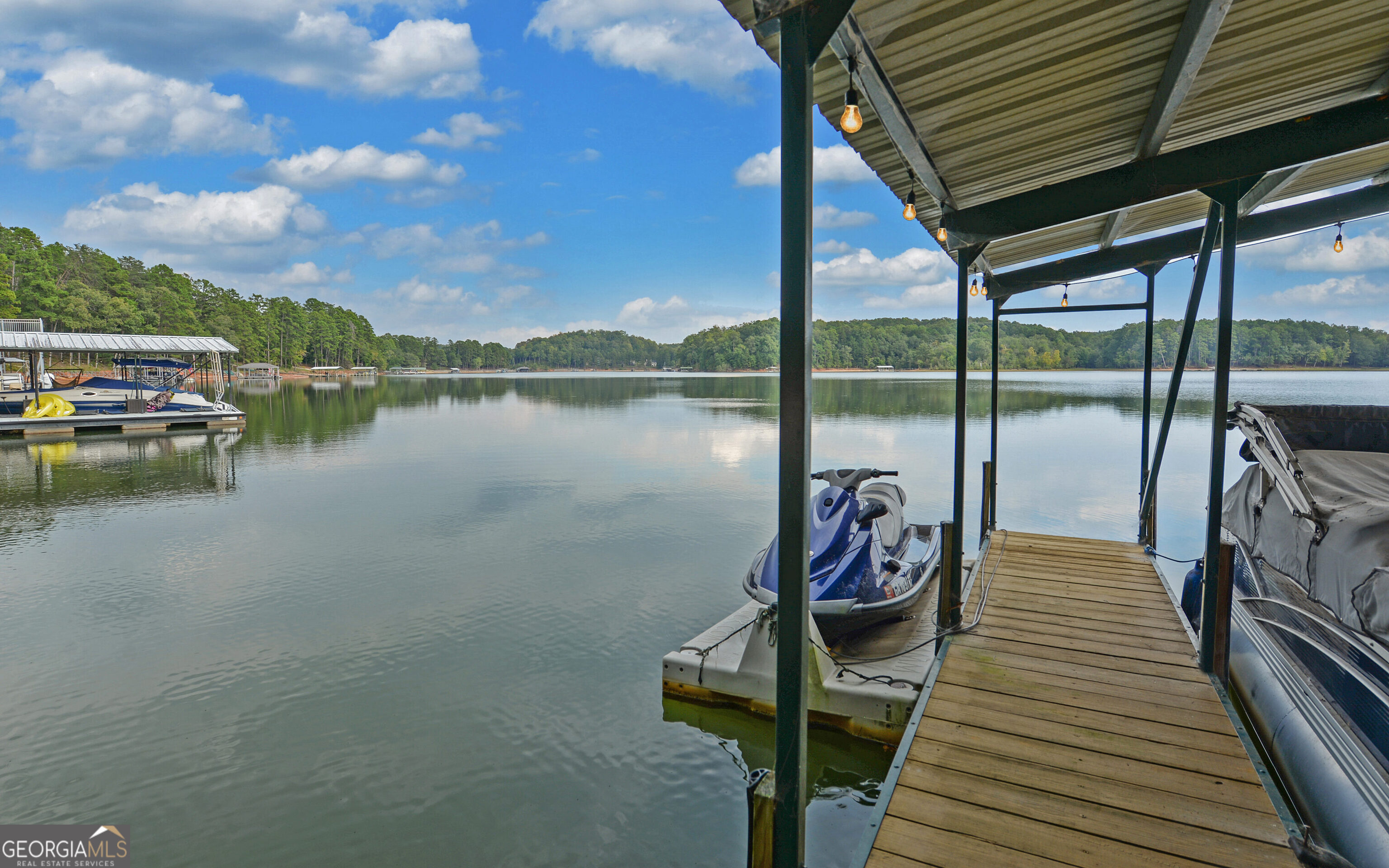 120 Ridgemore Circle Toccoa, GA 30577 - Photo 46 of 48 a view of a lake with couches chairs and wooden floor