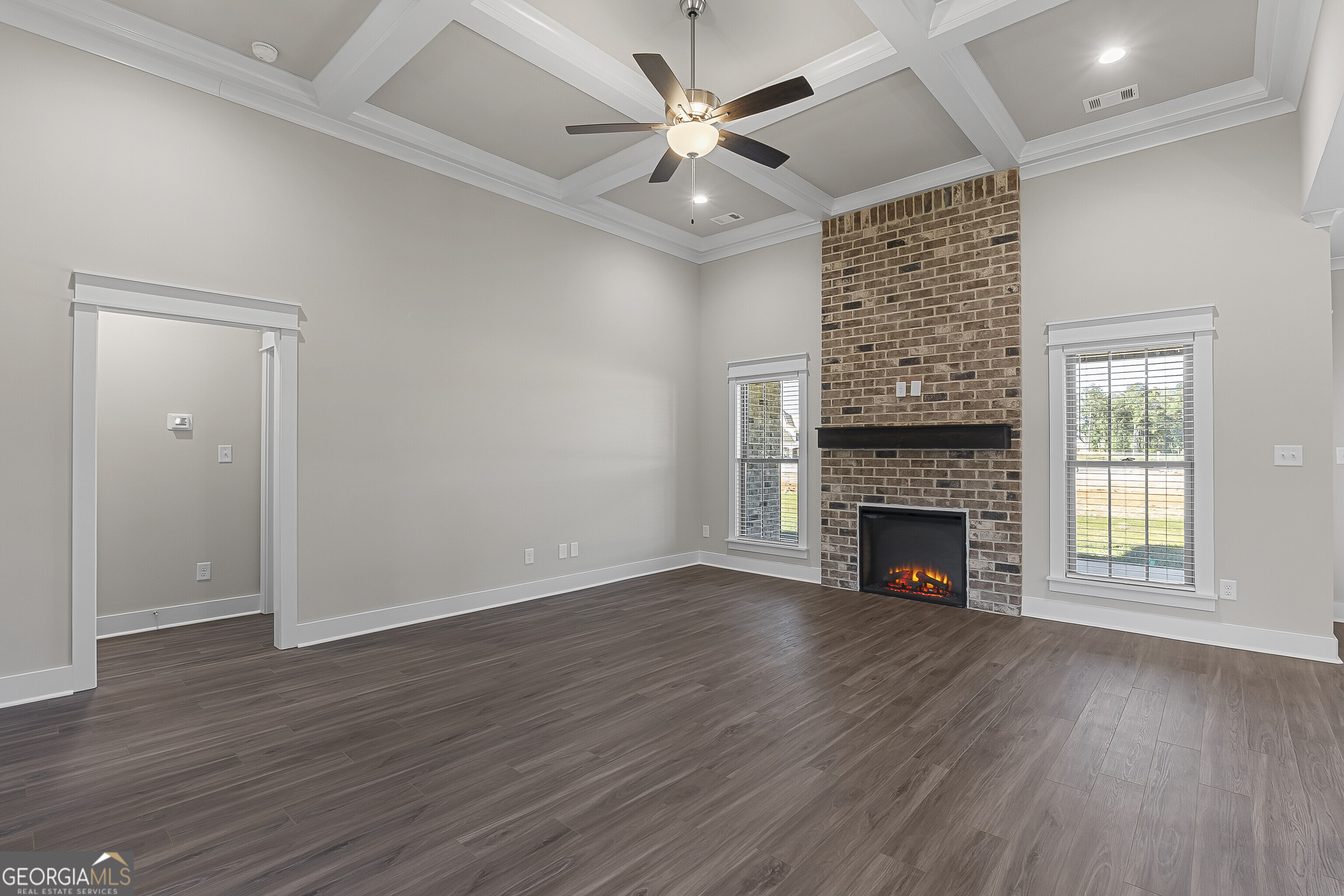 200 Emberwood Way Kathleen, GA 31047 - Photo 16 of 63 an empty room with wooden floor a fireplace a ceiling fan and closet