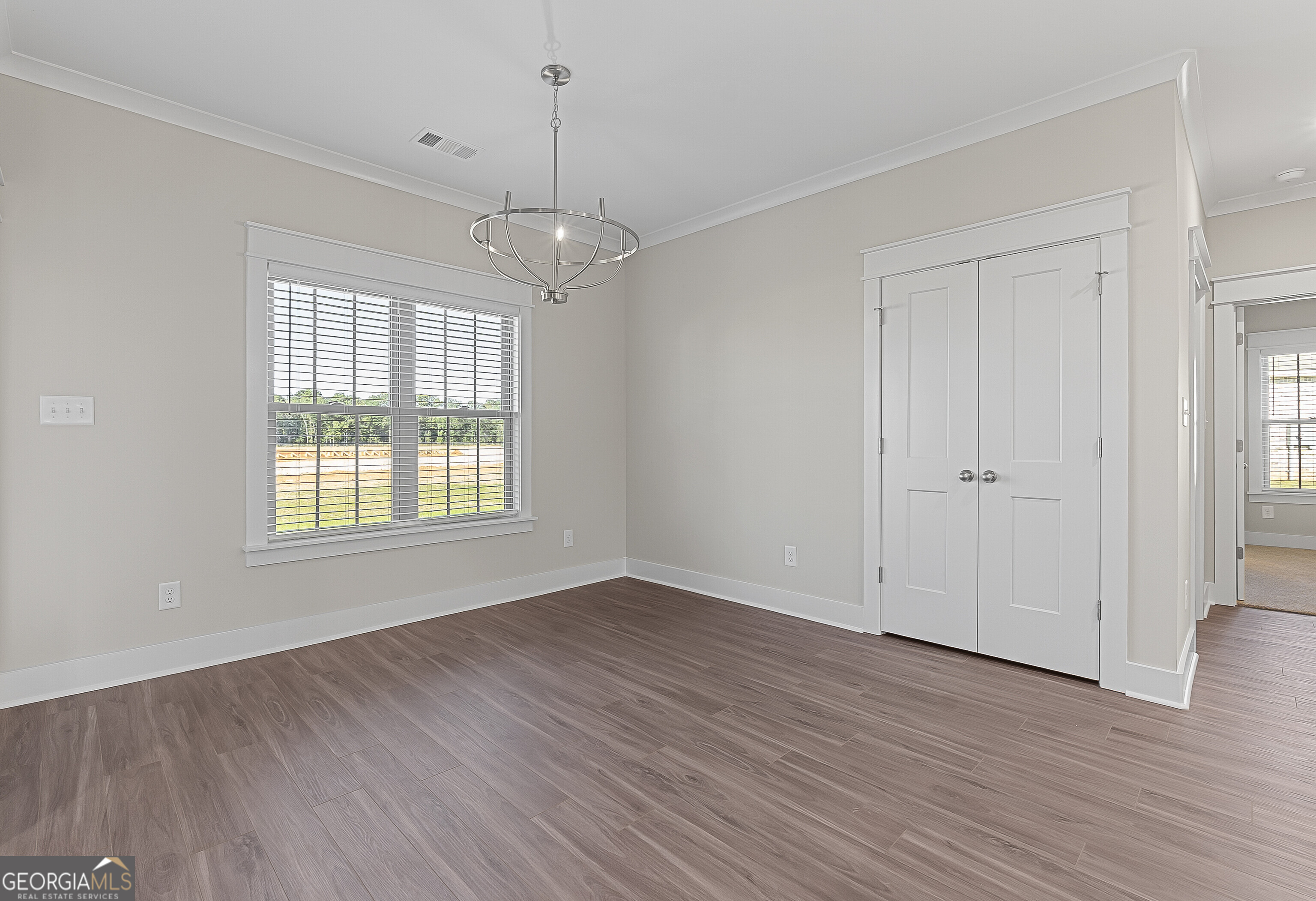 200 Emberwood Way Kathleen, GA 31047 - Photo 20 of 63 an empty room with wooden floor cabinet and windows