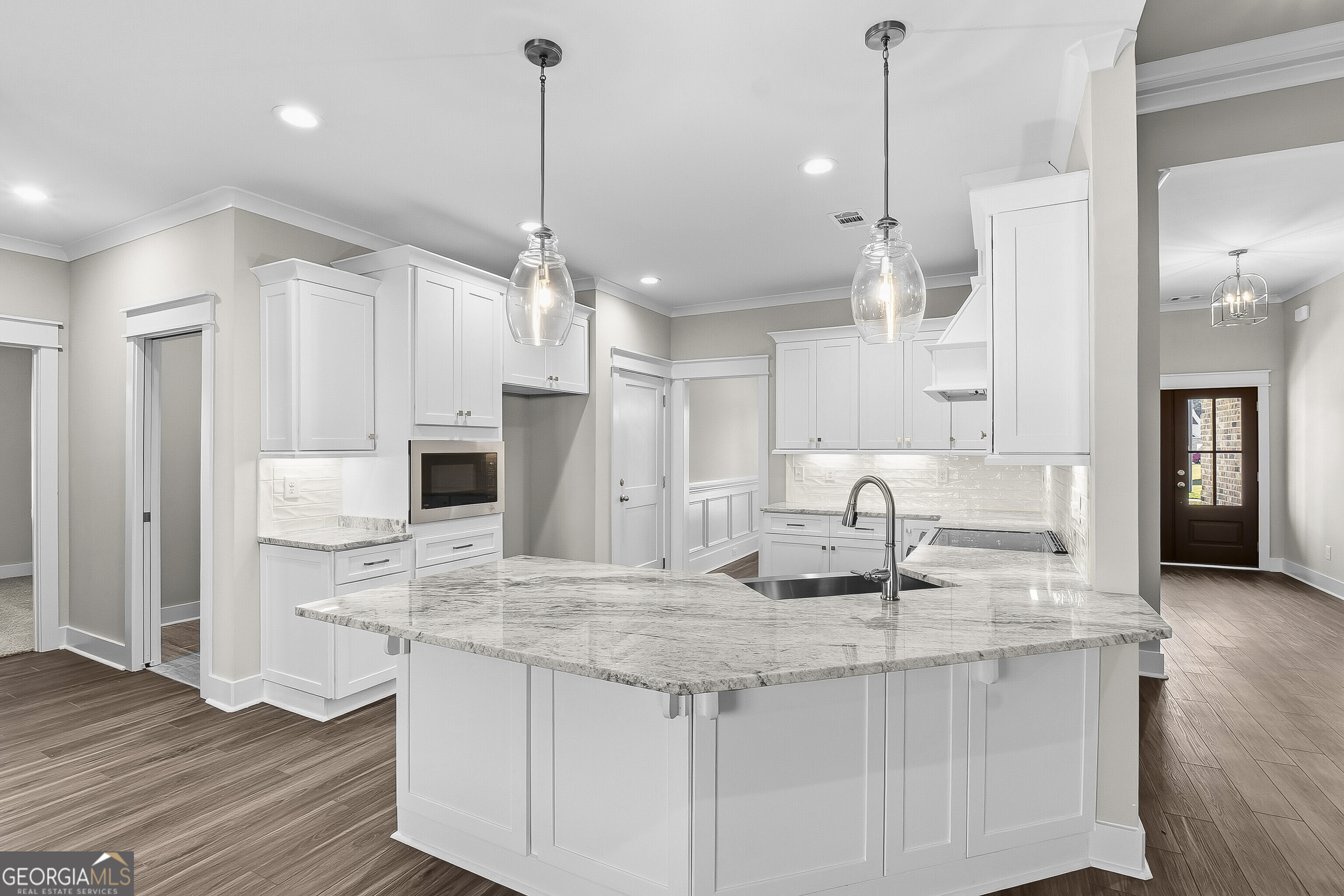 200 Emberwood Way Kathleen, GA 31047 - Photo 22 of 63 a kitchen with kitchen island granite countertop a stove a sink a center island a refrigerator and a wooden floor