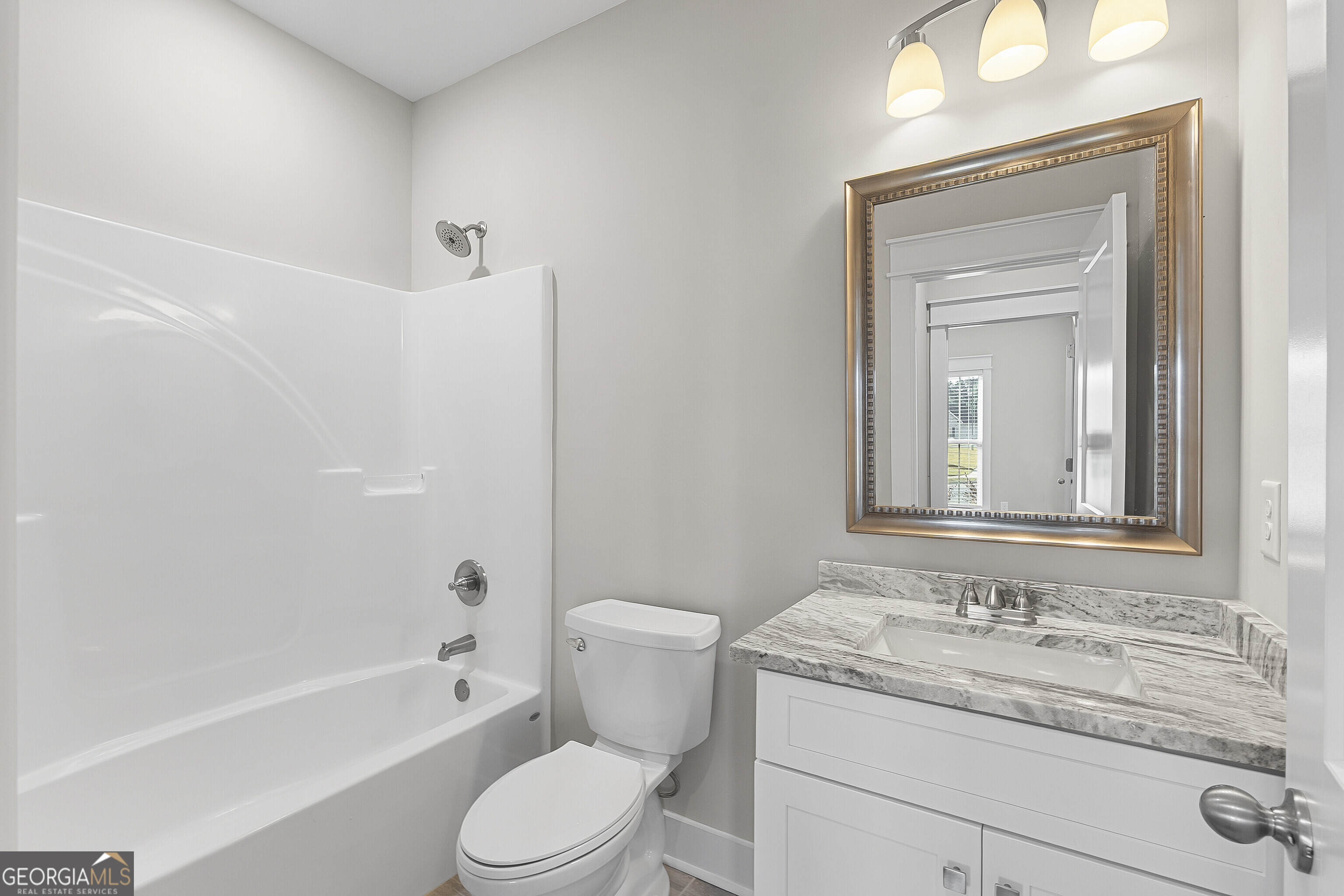 200 Emberwood Way Kathleen, GA 31047 - Photo 44 of 63 a bathroom with a granite countertop toilet a sink and a bathtub