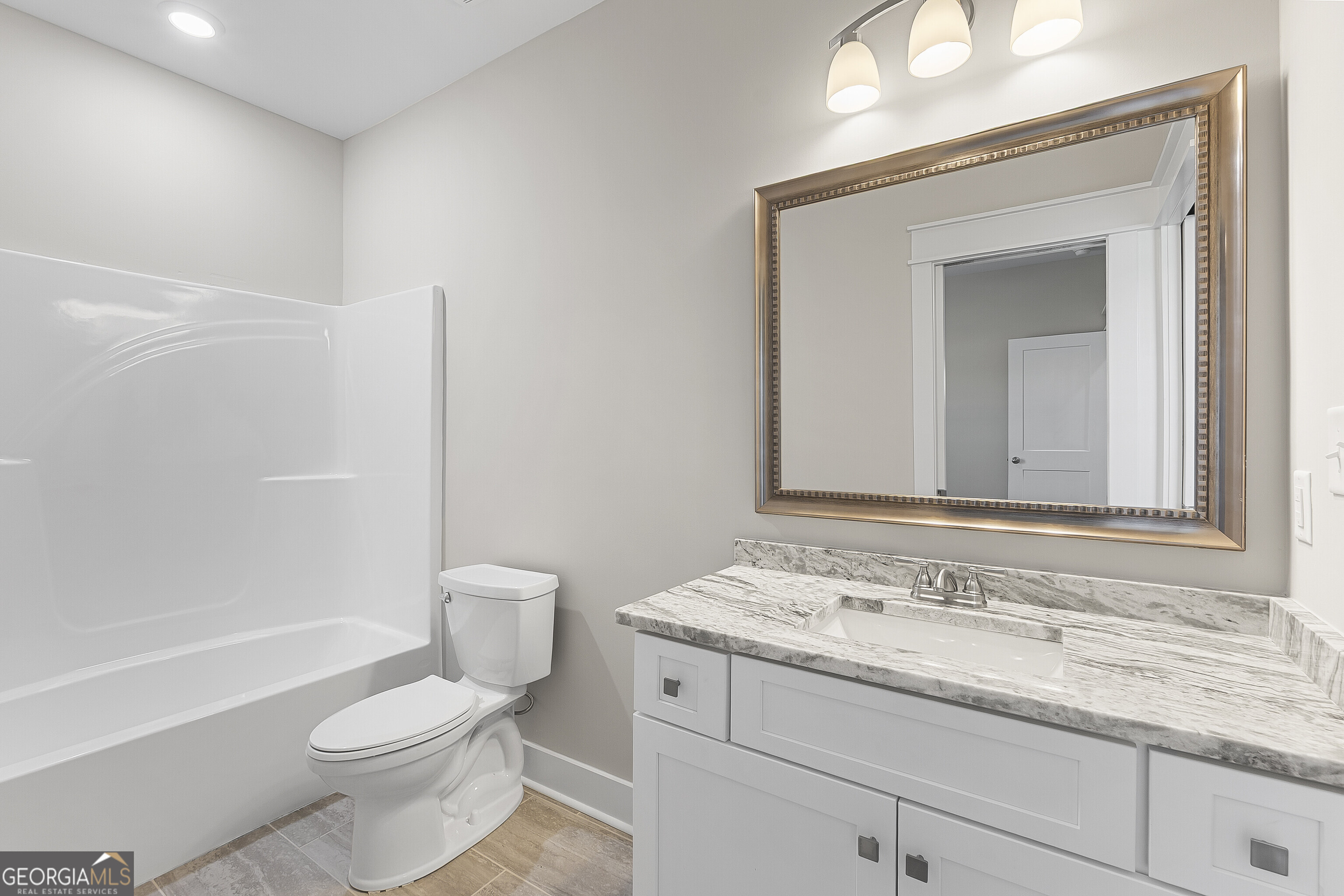 200 Emberwood Way Kathleen, GA 31047 - Photo 48 of 63 a bathroom with a granite countertop toilet a sink and a bathtub