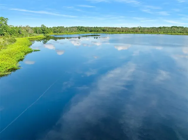 a view of a lake with houses in the back