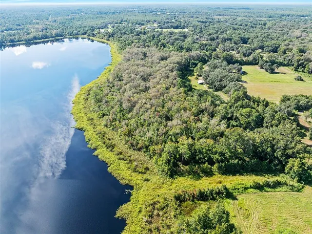 an aerial view of a houses with a lake view