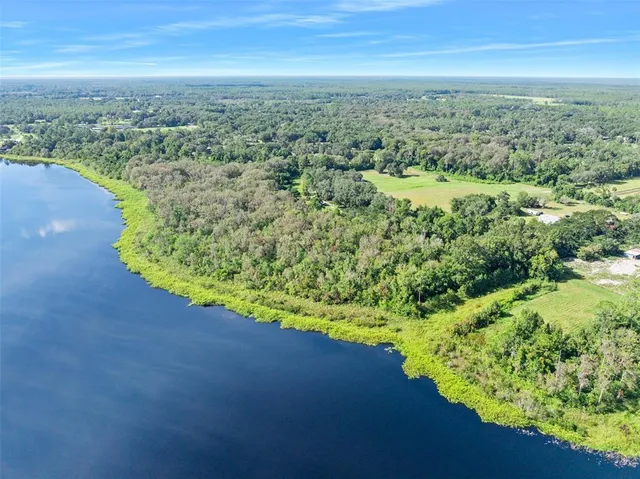 an aerial view of a houses with a yard