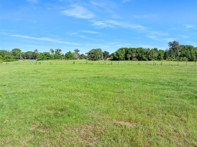 a view of building with green field