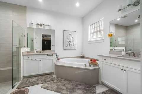 a bathroom with a shower sink and mirror