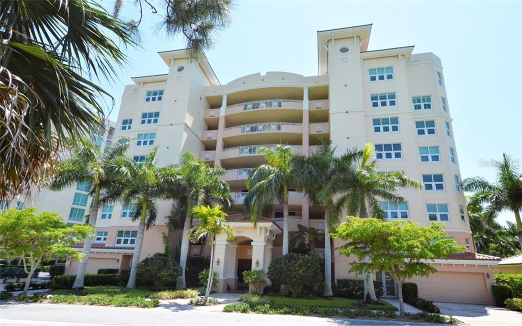 3621 North Point Road, Unit 402 Osprey, FL 34229 - Photo 1 of 1 a front view of multi story residential apartment building with yard and parking space
