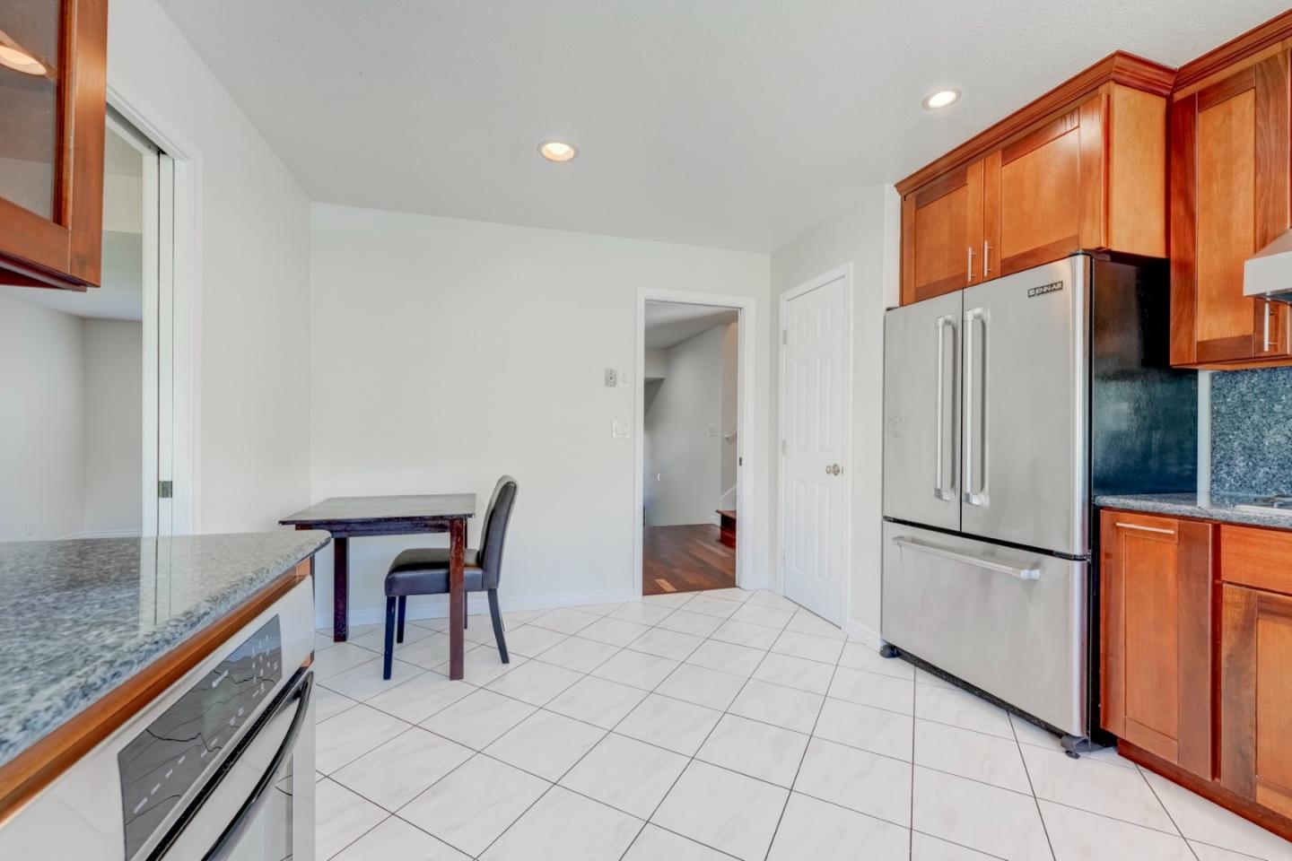 2321 Oak Flat Road San Jose, CA 95131 - Photo 13 of 43 a kitchen with stainless steel appliances granite countertop a refrigerator and a stove top oven