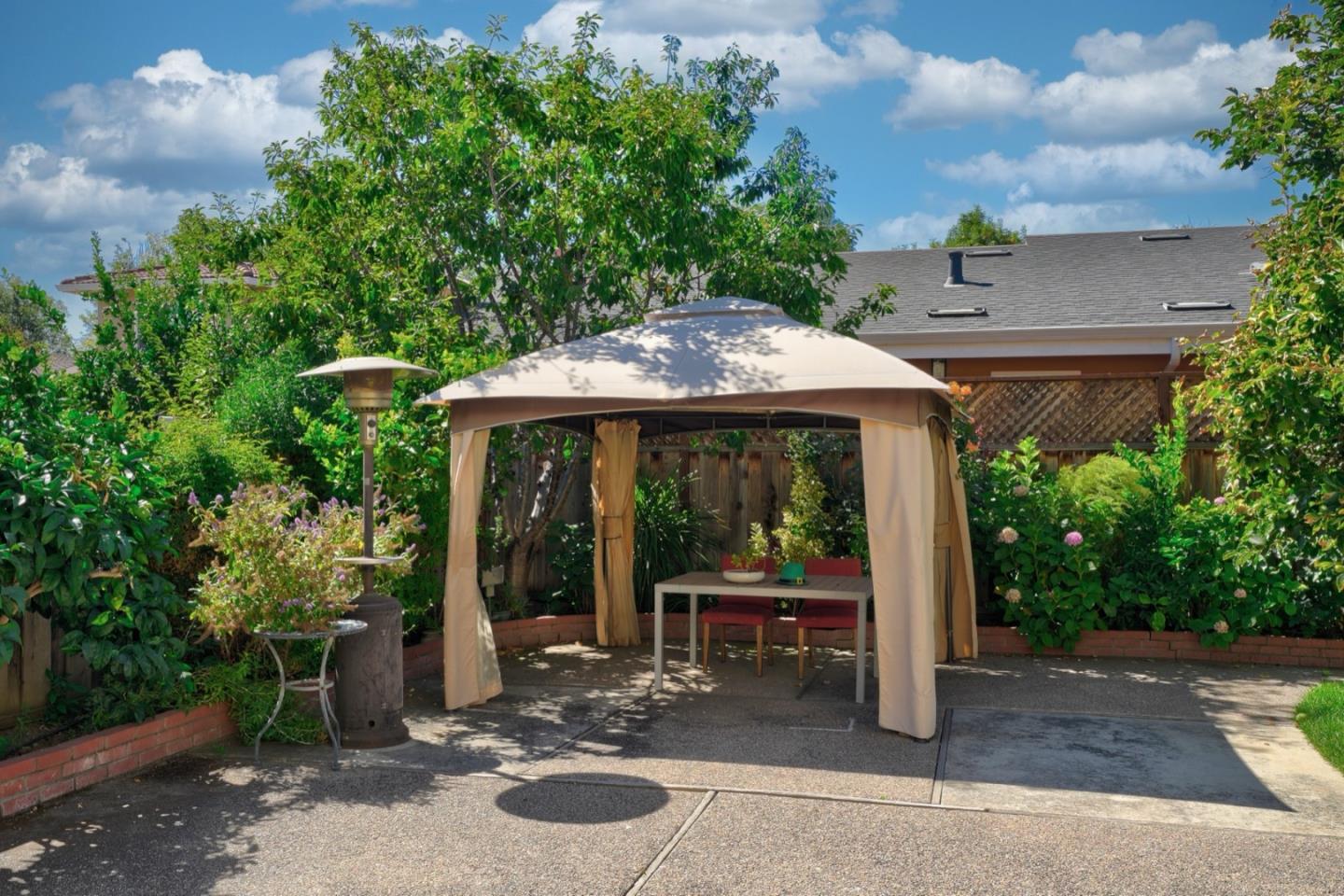 2321 Oak Flat Road San Jose, CA 95131 - Photo 5 of 43 a view of a patio with table and chairs potted plants with wooden fence