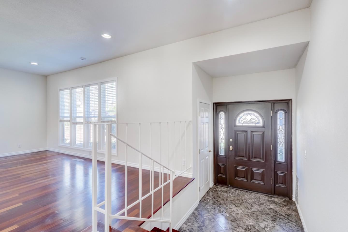2321 Oak Flat Road San Jose, CA 95131 - Photo 7 of 43 a view of a hallway with wooden floor and windows