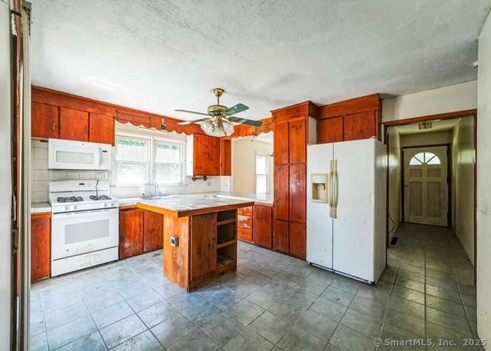 416 Hanover Road Scotland, CT 06330 - Photo 12 of 20 a kitchen with stainless steel appliances granite countertop a stove and a refrigerator