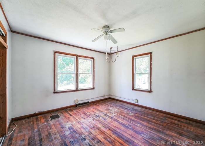 416 Hanover Road Scotland, CT 06330 - Photo 18 of 20 a view of an empty room with a window and wooden floor