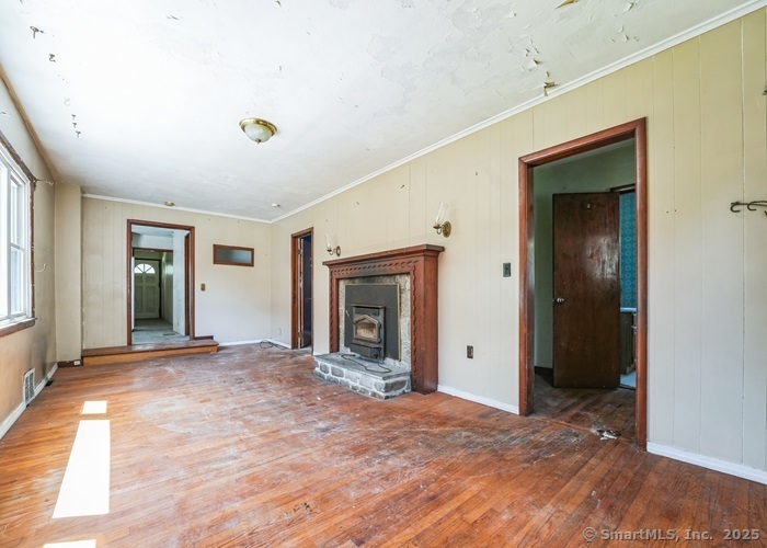 416 Hanover Road Scotland, CT 06330 - Photo 7 of 20 a view of an empty room with wooden floor and a window