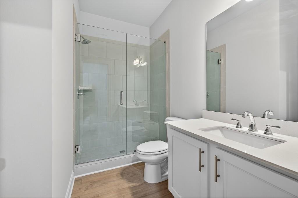 5566 Spring Street Flowery Branch, GA 30542 - Photo 20 of 66 a bathroom with a sink a toilet and shower