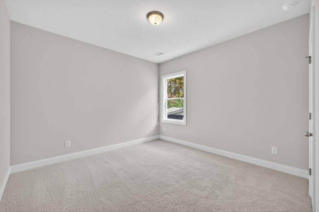 5566 Spring Street Flowery Branch, GA 30542 - Photo 21 of 66 an empty room with windows