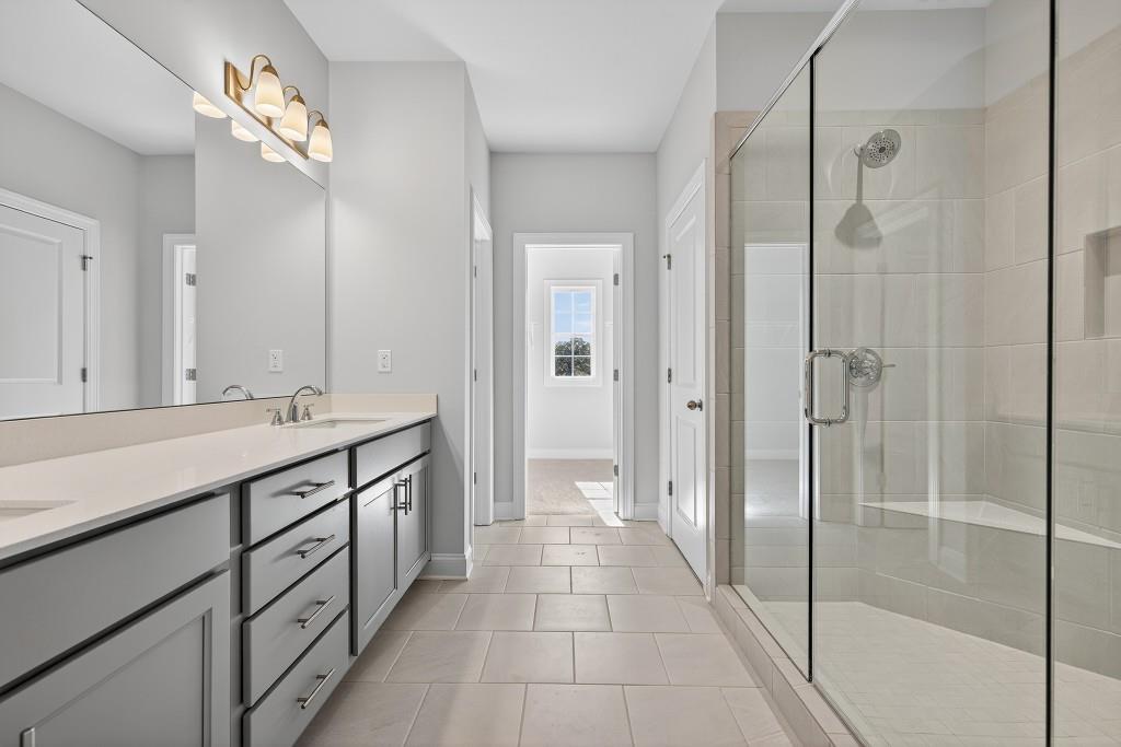 5566 Spring Street Flowery Branch, GA 30542 - Photo 33 of 66 a bathroom with a double vanity sink and a mirror