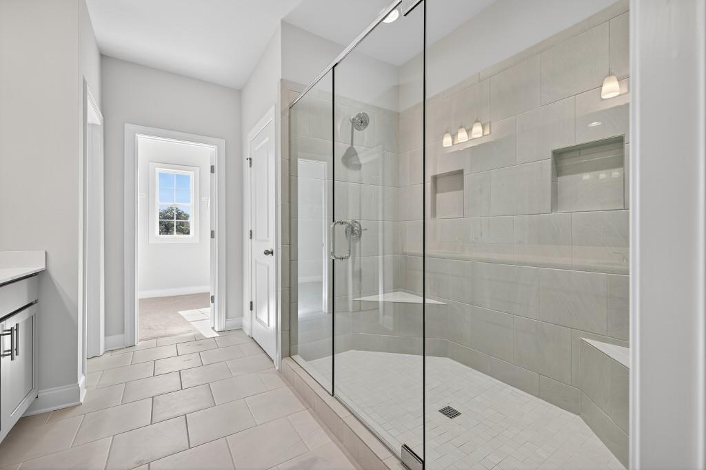 5566 Spring Street Flowery Branch, GA 30542 - Photo 34 of 66 a bathroom with a shower and a sink