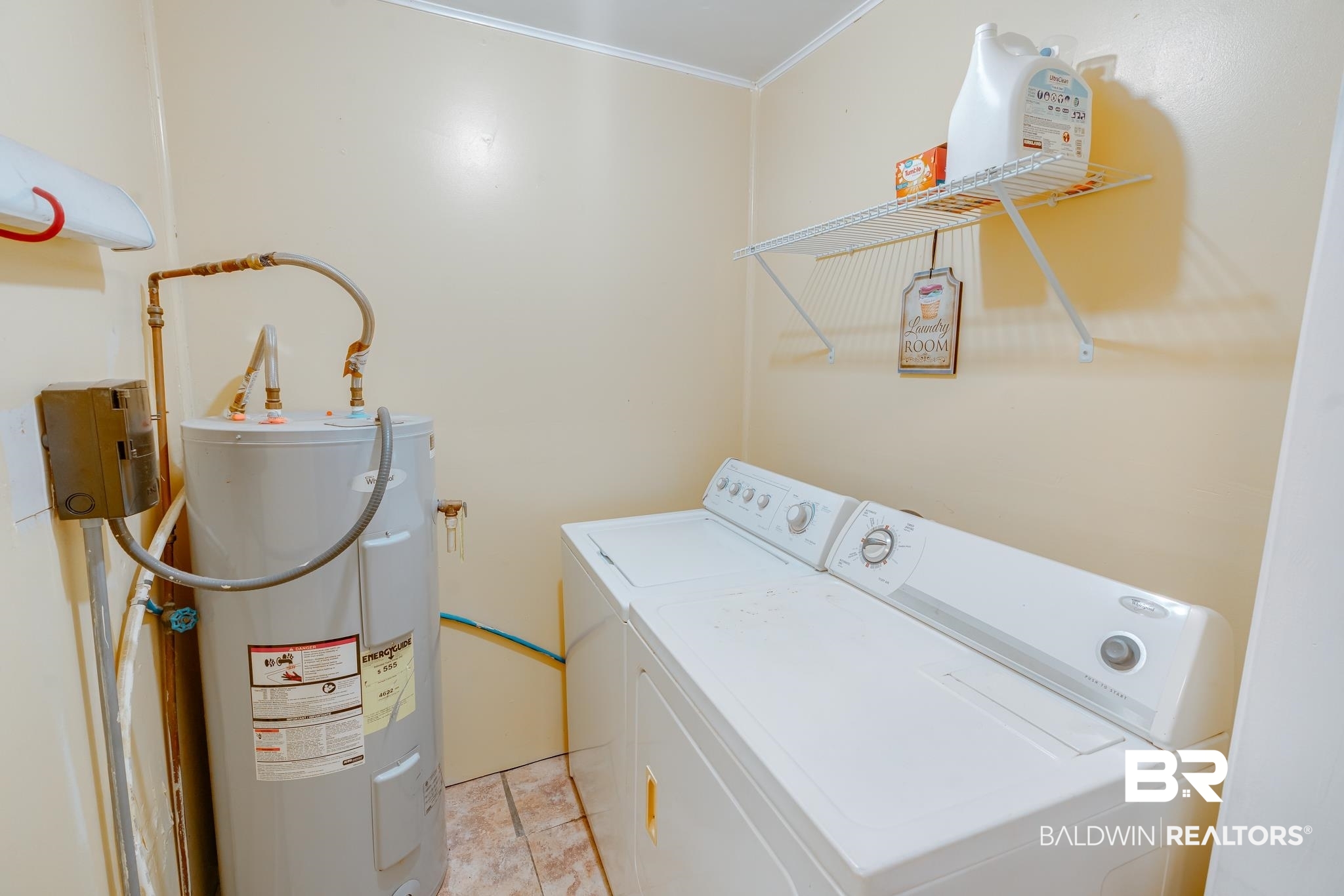315 Fourth Avenue Chickasaw, AL 36611 - Photo 26 of 28 Laundry room featuring washer and dryer, water heater, ornamental molding, and laundry area