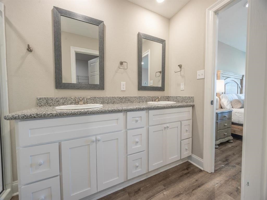23906 Peppermint Street Elberta, AL 36530 - Photo 9 of 14 Bathroom featuring double vanity, ensuite bathroom, and dark wood-style flooring