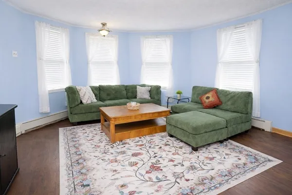 a living room with a couch and a chandelier