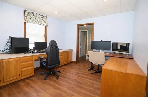 a view of a workspace with furniture and a window