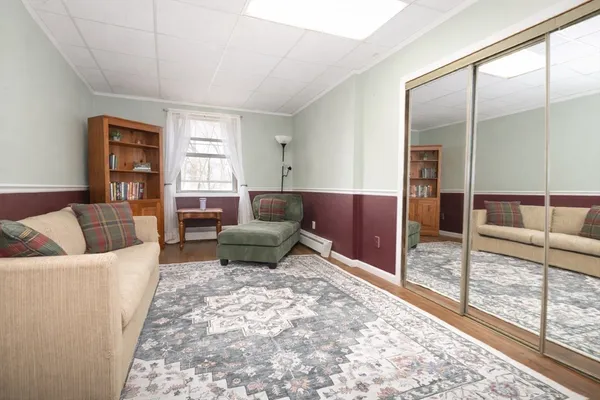 a living room with furniture and a floor to ceiling window