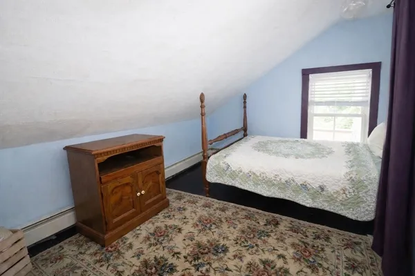 a bedroom with a bed and a dresser