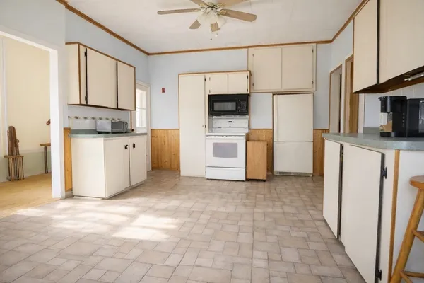 a kitchen with stainless steel appliances a refrigerator sink and microwave