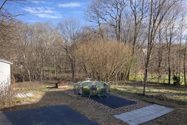 a backyard of a house with table and chairs