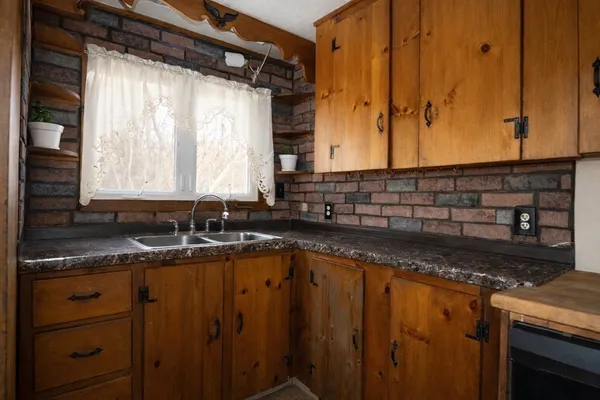 a kitchen with granite countertop a sink and a window