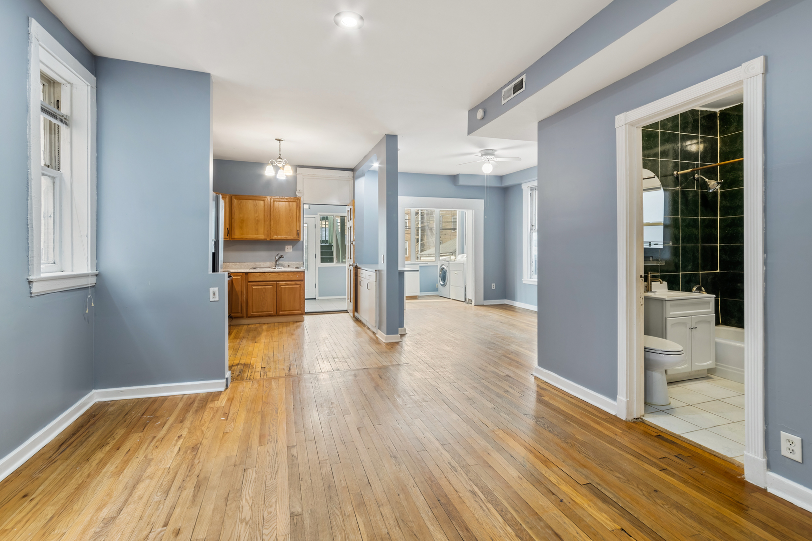 4434 North Drake Avenue, Unit 1 Chicago, IL 60625 - Photo 3 of 11 a view of a hallway with wooden floor and a living room