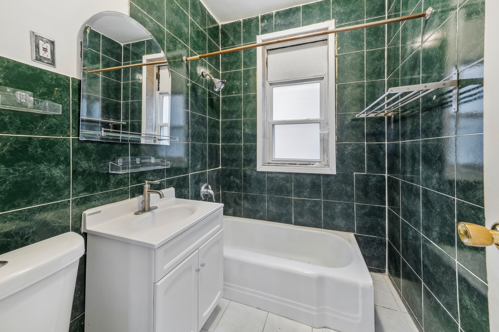 4434 North Drake Avenue, Unit 1 Chicago, IL 60625 - Photo 8 of 11 a bathroom with a sink mirror toilet and bathtub