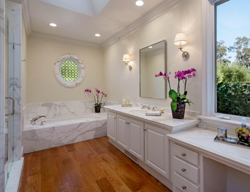 511 Las Fuentes Drive Santa Barbara, CA 93108 - Photo 3 of 11 a bathroom with a granite countertop sink a large mirror and a bathtub