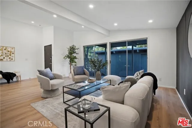 a living room with furniture and potted plant