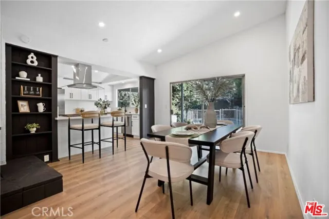 a dining room with furniture and wooden floor