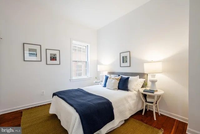 a bedroom with a bed and a night stand