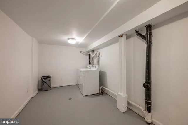 a view of storage and utility room with closet