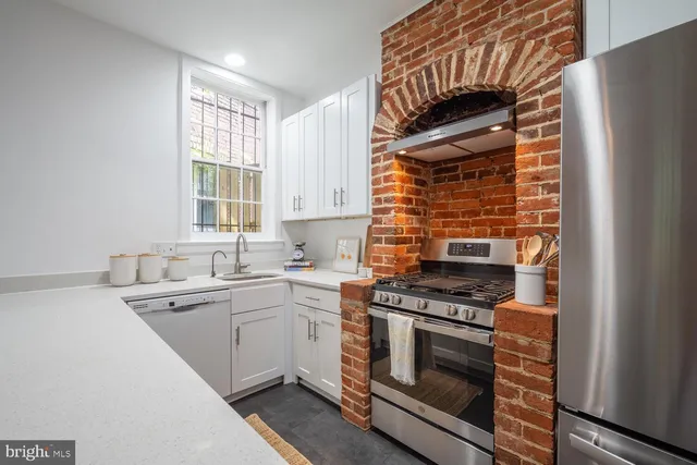 a kitchen with stainless steel appliances a stove sink and cabinets