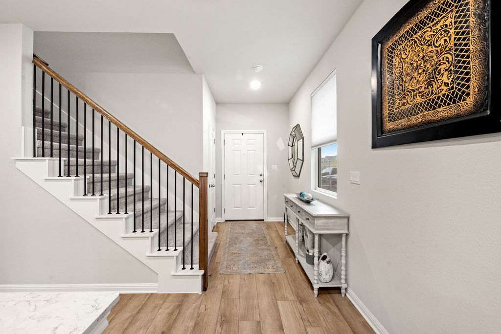 2417 Roosevelt Road Leander, TX 78641 - Photo 33 of 40 Entryway featuring light wood-style floors and stairway