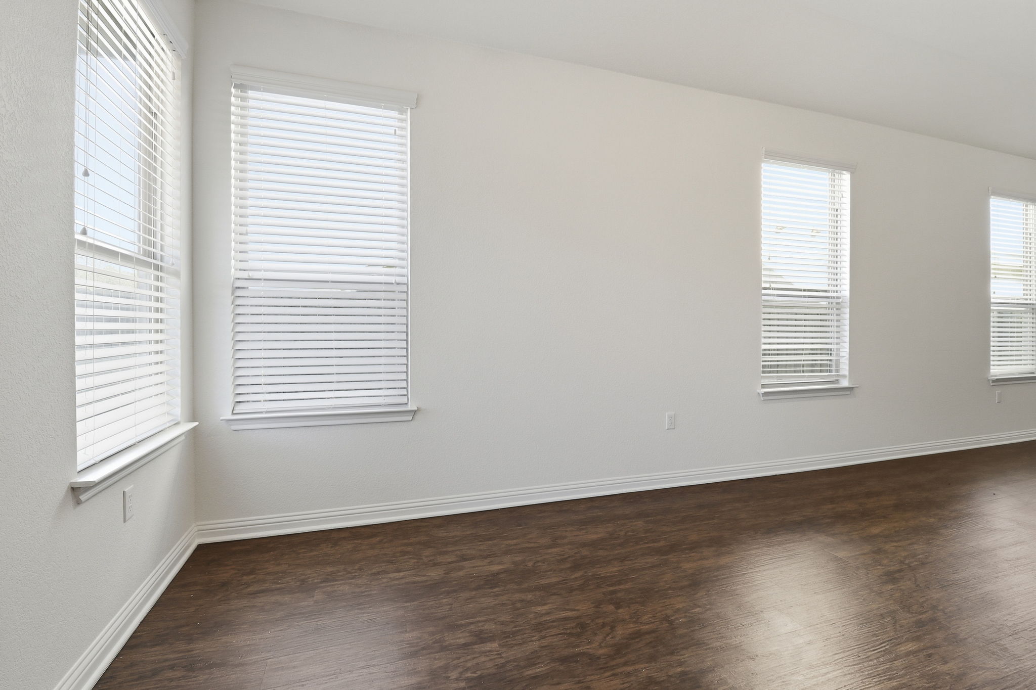 5908 Gerard Drive Austin, TX 78744 - Photo 12 of 34 Empty room featuring dark wood-style floors and baseboards