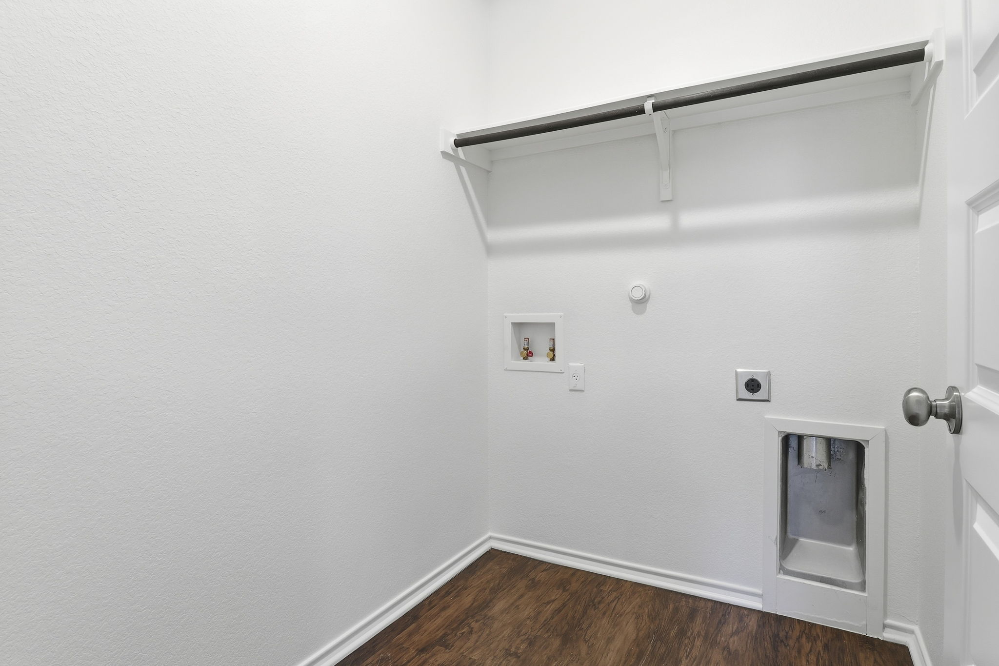 5908 Gerard Drive Austin, TX 78744 - Photo 27 of 34 Washroom with hookup for a gas dryer, dark wood finished floors, hookup for a washing machine, and hookup for an electric dryer