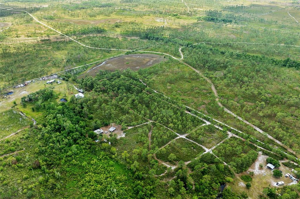 0 Palm Frond Road St. Cloud, FL 34773 - Photo 10 of 12 a view of a field of grass and white house
