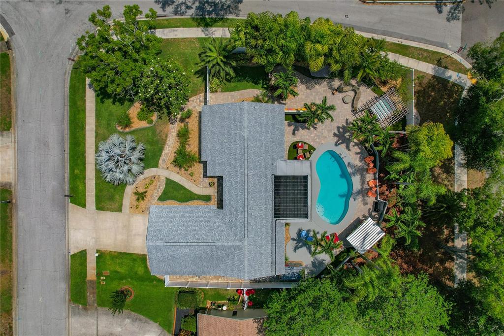 an aerial view of a house with a yard and garden