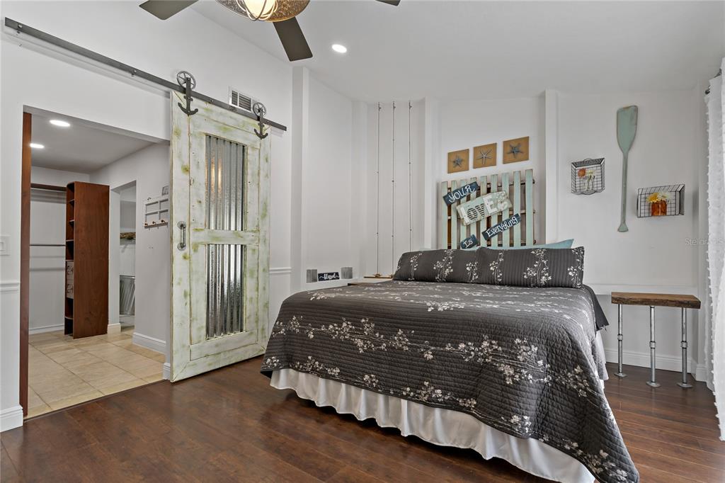 808 Rustic Oaks Drive Palm Harbor, FL 34684 - Photo 23 of 55 a bedroom with a bed and painting on the wall