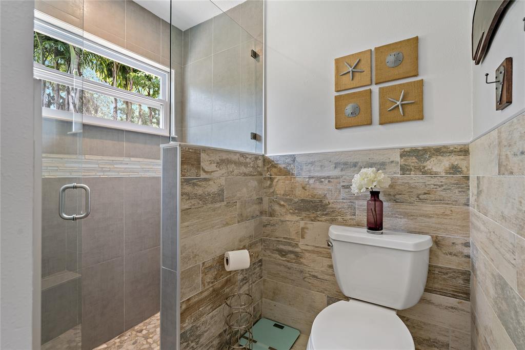 808 Rustic Oaks Drive Palm Harbor, FL 34684 - Photo 29 of 55 a bathroom with a toilet and a shower